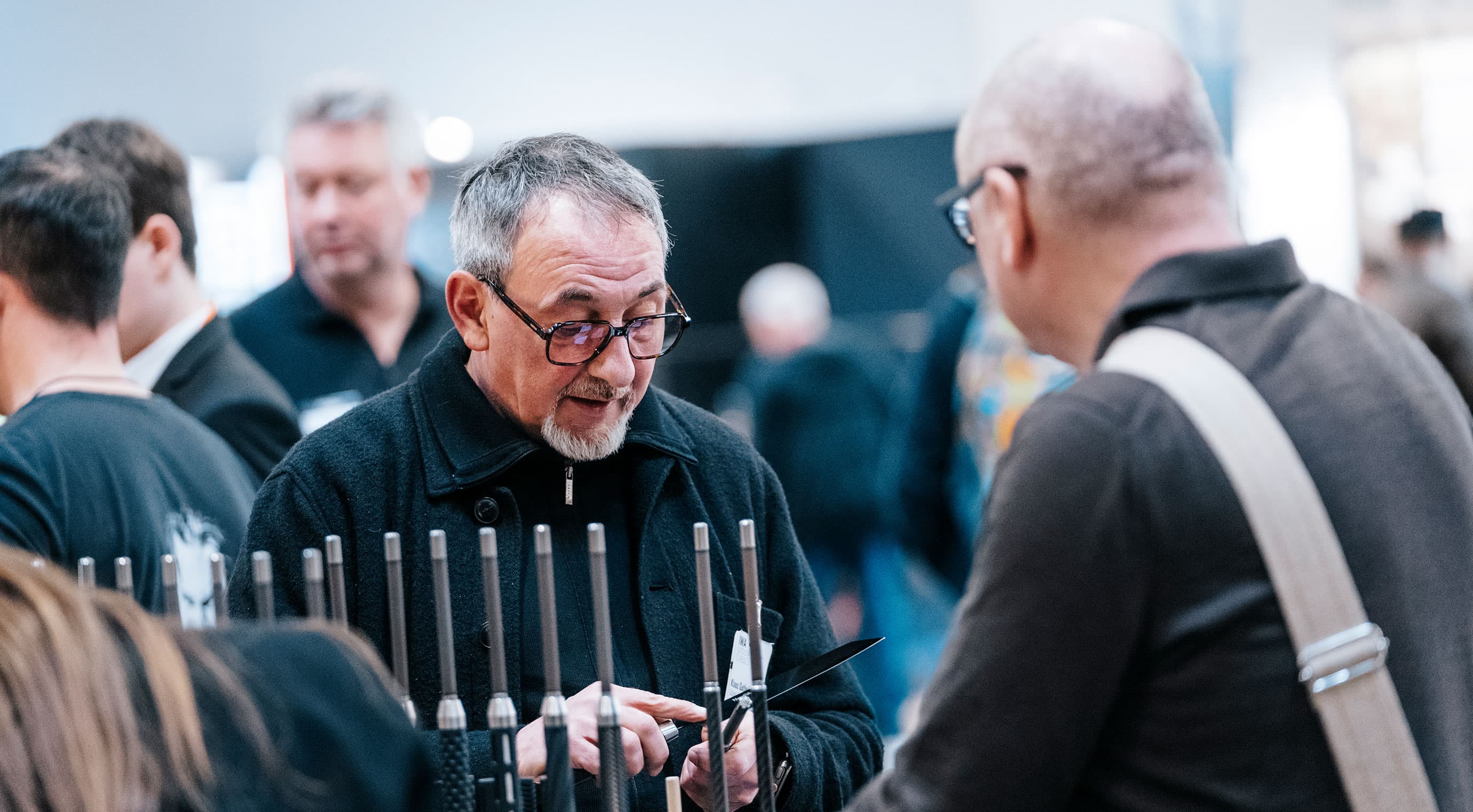 Knife exhibitor presents his product to a visitor
